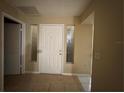 Entryway with a white front door flanked by side windows at 12512 Wisconsin Woods Ln, Orlando, FL 32824