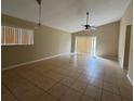 Spacious living room features neutral paint and tile flooring at 12512 Wisconsin Woods Ln, Orlando, FL 32824
