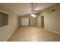 Spacious living room features neutral paint and tile flooring at 12512 Wisconsin Woods Ln, Orlando, FL 32824