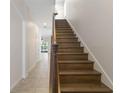 Wooden staircase leading upstairs, with decorative railings and a view into the home at 141 Mitchell Creek Way, Oviedo, FL 32765
