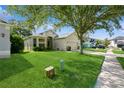 Attractive home with lush front yard and well-maintained landscaping, showcasing curb appeal, and a two car garage at 14208 Morning Frost Dr, Orlando, FL 32828