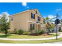 Two-story home on a corner lot with a lush lawn and landscaping at 1504 Oak Marsh Loop, Davenport, FL 33837