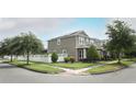 View of the side of a two-story home featuring a well-maintained lawn and a white fenced yard at 15849 Sweet Lemon Way, Winter Garden, FL 34787