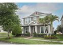 Charming two-story home with a well-manicured lawn, lush landscaping, and inviting front porch at 15849 Sweet Lemon Way, Winter Garden, FL 34787