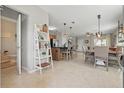Spacious open-concept living area featuring tile flooring, a kitchen island, and abundant natural light at 16163 Pebble Bluff Loop, Winter Garden, FL 34787