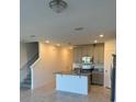 Modern kitchen features granite countertops, stainless appliances, and open layout at 16468 Happy Eagle Dr, Clermont, FL 34714