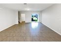 Spacious living room with ceramic tile flooring and sliding glass doors to the backyard at 16518 Brook Springs Aly, Winter Garden, FL 34787