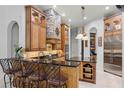 This kitchen boasts a stone range hood, granite countertops, and stainless steel appliances at 1724 Cottonwood Creek Pl, Lake Mary, FL 32746