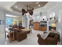The spacious living room features a fireplace, wet bar and two ceiling fans at 1724 Cottonwood Creek Pl, Lake Mary, FL 32746