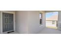 Close up of the front door and the covered porch with white railings and stone supports at 1757 Brush Cherry Pl, Ocoee, FL 34761