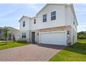 Attractive two-story home with a two-car garage and brick-paved driveway at 2055 Town Pasture Dr, Eustis, FL 32726