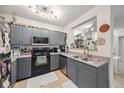 Cozy kitchen with gray cabinets, laminate countertops, stainless steel appliances and double sinks at 206 E South St # 3008, Orlando, FL 32801