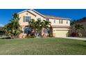 Beautiful two-story home with green shutters, a well-maintained lawn, and mature palm trees at 207 Black Springs Ln, Winter Garden, FL 34787