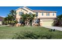Charming two-story home with manicured lawn, colorful front door, and vibrant tropical landscaping at 207 Black Springs Ln, Winter Garden, FL 34787