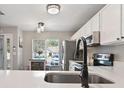 Modern kitchen with white cabinets and stainless steel appliances at 2112 Cypress Bay Blvd, Kissimmee, FL 34743