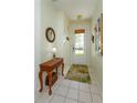 Inviting foyer showcasing tiled floors, decorative table, and a charming rug near the door at 2348 Silver Palm, Kissimmee, FL 34747