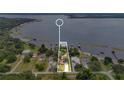 Aerial view of lakefront property with mature trees, private dock, and proximity to waterways at 3085 Vest Rd, St Cloud, FL 34772