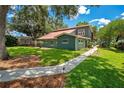 The home has a lush lawn, landscaping, and a concrete walkway leading to the front of the house at 3085 Vest Rd, St Cloud, FL 34772