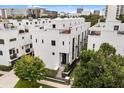 Modern multi-level townhouse showcasing sleek lines and rooftop terraces in a vibrant urban setting at 356 S Osceola Ave # 19, Orlando, FL 32801