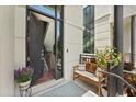 Inviting front entrance with open door, bench seating, and decorative potted plants at 356 S Osceola Ave # 19, Orlando, FL 32801