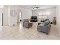 Spacious living room featuring tile flooring, neutral tones, and ample natural light at 3566 Southern Cross Loop, Kissimmee, FL 34744