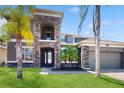 Elegant two-story home boasting a stone facade, attached garage, and well-manicured lawn at 4002 Scarlet Branch Rd, Orlando, FL 32824