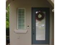 Close-up of front door with blue paint, glass, sidelight, and decorative wreath at 411 Evening Sky Dr, Oviedo, FL 32765