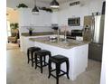 Bright kitchen features white cabinets, stainless steel appliances and granite countertops at 411 Evening Sky Dr, Oviedo, FL 32765
