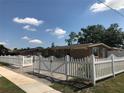 Charming single-story home with brick driveway and white picket fence at 4251 Anthony Lane, Orlando, FL 32822