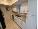 Kitchen with stainless steel appliances, granite countertops and modern white cabinets at 4328 Aqua Vista Dr # B, Orlando, FL 32839