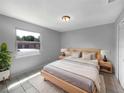 Cozy bedroom featuring a bed, a window offering natural light, and tile flooring at 52 Hydrangea Ln, Debary, FL 32713