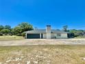 Single-story home with a two-car garage, neutral colors, and a spacious lot, perfect for outdoor activities at 6001 Beau Ln, Orlando, FL 32808