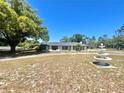 Classic one-story home with a traditional design, a beautiful fountain and a large lawn area at 6001 Beau Ln, Orlando, FL 32808