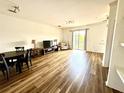 Bright living room and dining area featuring wood-look flooring and sliding glass doors at 6117 Metrowest Blvd # 106, Orlando, FL 32835