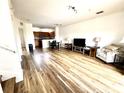 Spacious living room featuring wood-look flooring and an open floor plan concept at 6117 Metrowest Blvd # 106, Orlando, FL 32835