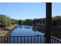 Balcony view of a wide canal with trees, landscaping, and three-story townhomes along the shore at 6117 Metrowest Blvd # 106, Orlando, FL 32835
