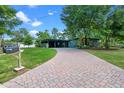 Charming home featuring a brick driveway, lovely yard, and inviting facade with a carport at 808 Denton Rd, Winter Park, FL 32792