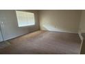 Bright, carpeted bedroom featuring a large window and neutral walls at 128 Water Front Way # 300, Altamonte Springs, FL 32701