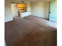A carpeted living room leads to an open kitchen area with an entrance at 128 Water Front Way # 300, Altamonte Springs, FL 32701