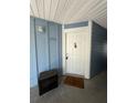 Condo unit entrance with a white door, blue siding, and a welcome mat at 2585 Grassy Point Dr # 313, Lake Mary, FL 32746