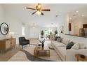 Bright, open living room featuring neutral décor, a ceiling fan, and seamless flow into the dining area at 2907 Southern Pines Loop, Clermont, FL 34711