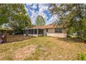 Spacious backyard with covered porch and mature landscaping at 3 Spring Lane Way, Ocala, FL 34472