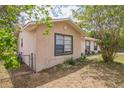 Side view of home showing fenced yard, window details, and corner lot at 3 Spring Lane Way, Ocala, FL 34472