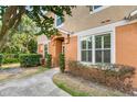 Charming townhouse featuring stucco facade, manicured landscaping, and inviting walkway to the front door at 3321 San Jacinto Cir # 116, Sanford, FL 32771