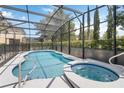 Screened-in pool and spa with clear blue water, offering a private outdoor retreat at 4201 Oakview Dr, Davenport, FL 33837