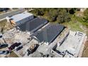 New homes under construction featuring modern design elements and a gray roof, near other structures at 59 W 10Th St, Apopka, FL 32703
