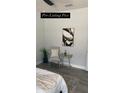 Neutral bedroom with modern art, chair, and side table at 59 W 10Th St, Apopka, FL 32703
