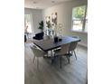 Modern dining room showcasing sleek furniture, neutral tones, contemporary art, and a view of the outdoors at 59 W 10Th St, Apopka, FL 32703