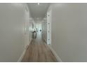Bright hallway with wood-style flooring that leads to other rooms of the house at 59 W 10Th St, Apopka, FL 32703