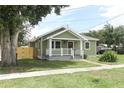 Well-kept home featuring a cozy front porch and lush green landscaping at 1312 7Th St, St Cloud, FL 34769